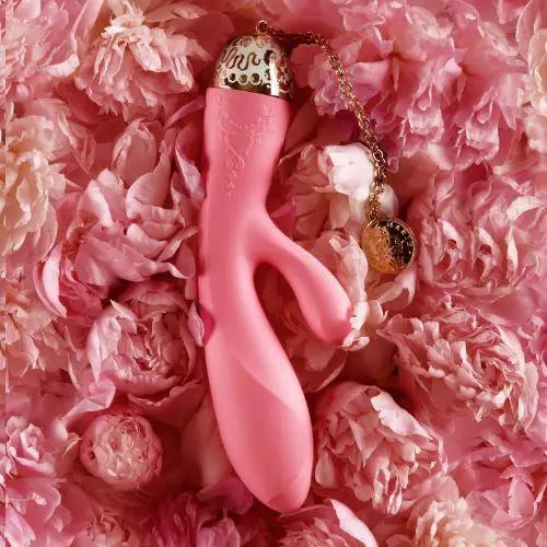 Pink sex toy surrounded by a bed of delicate pink peonies